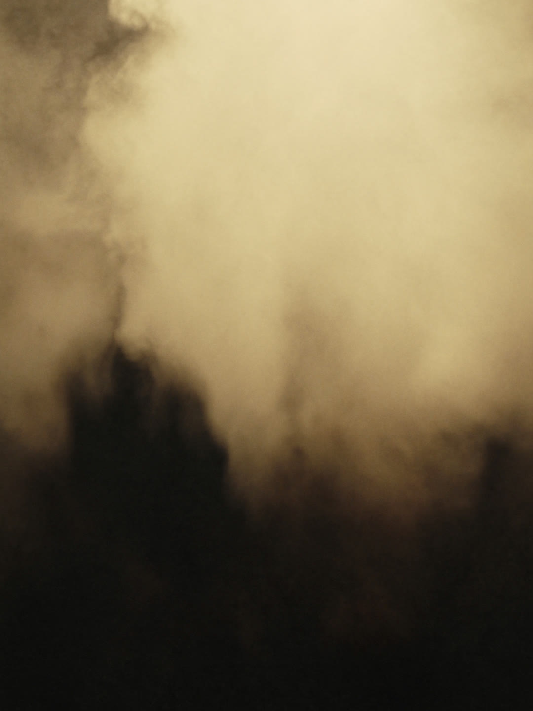 Steam rising in warm light, part of the natural facial process