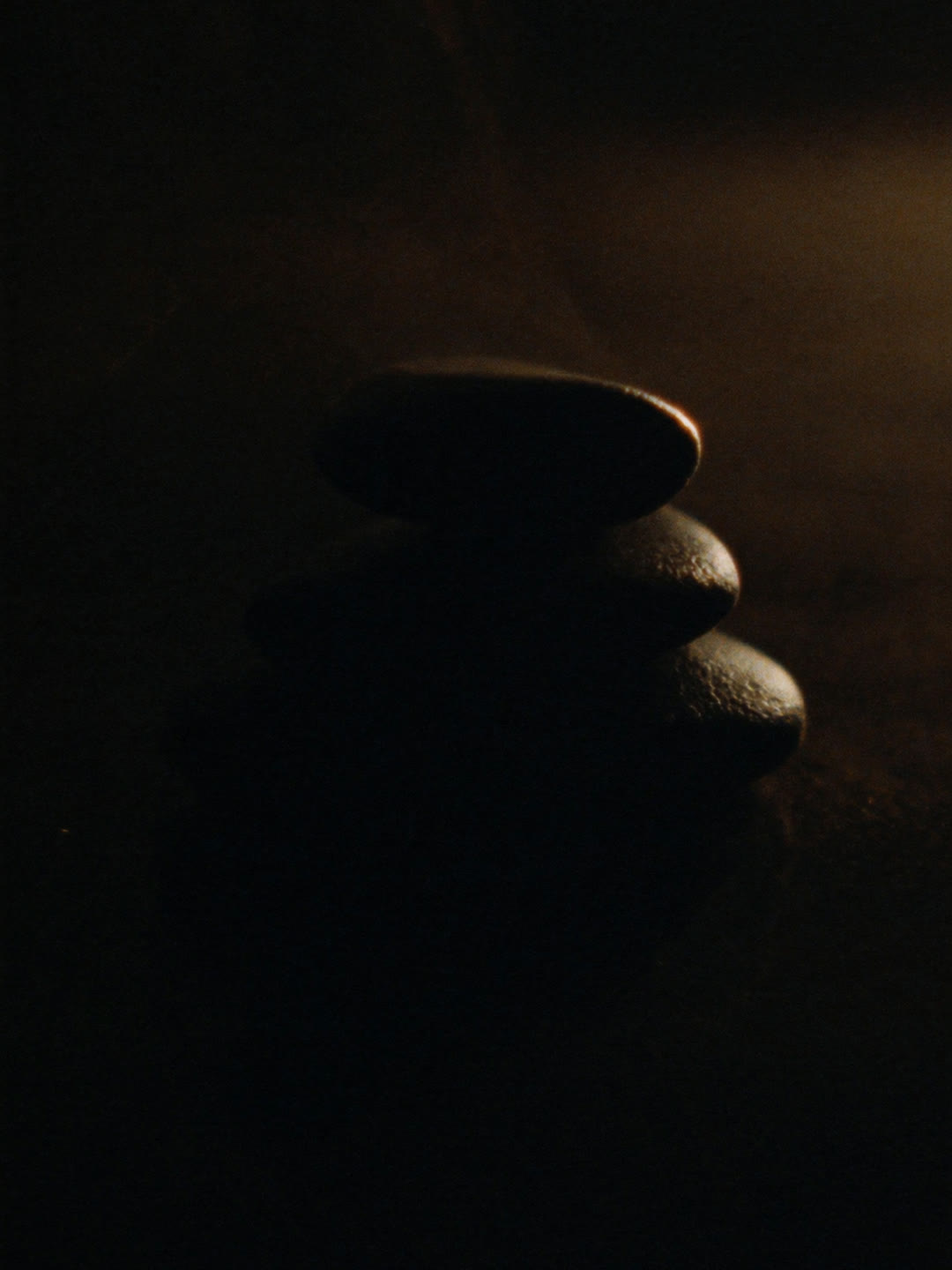 Three smooth stones at rest, warmed and ready for treatment